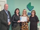 Link's Grant Alexander, Sarah Smith and Nicky Paton receive the certificate from the DWP's Gill Jardine