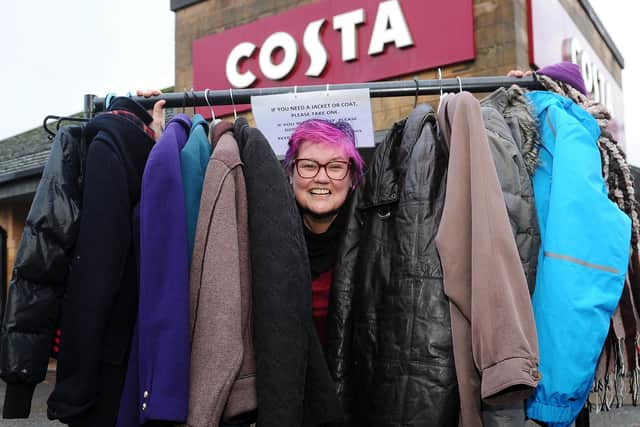 Debbie Beveridge with some of the donated coats.