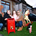 Senga Morris, Freya Ritchie , 11, Jorja Ritchie, 3, and Nicole Ritchie have been passing on children's Christmas letters to Santa with their special post box in their Wallace Street Winter Wonderland 
(Picture: Michael Gillen, National World)