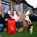 Senga Morris, Freya Ritchie , 11, Jorja Ritchie, 3, and Nicole Ritchie have been passing on children's Christmas letters to Santa with their special post box in their Wallace Street Winter Wonderland 
(Picture: Michael Gillen, National World)