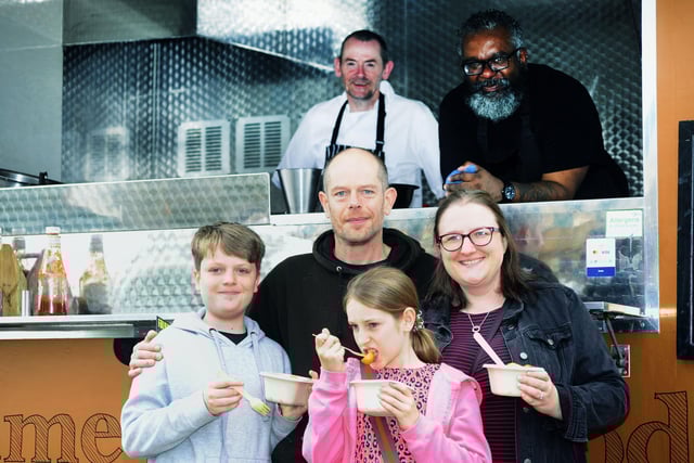 Tasting Prime Street Food from Linlithgow are Dexter (11), dad Ujam, Lyla (9) and mum Lynsey Hansford. Prime Street Food staff are Gary McAvoy and Nicholas Runga.