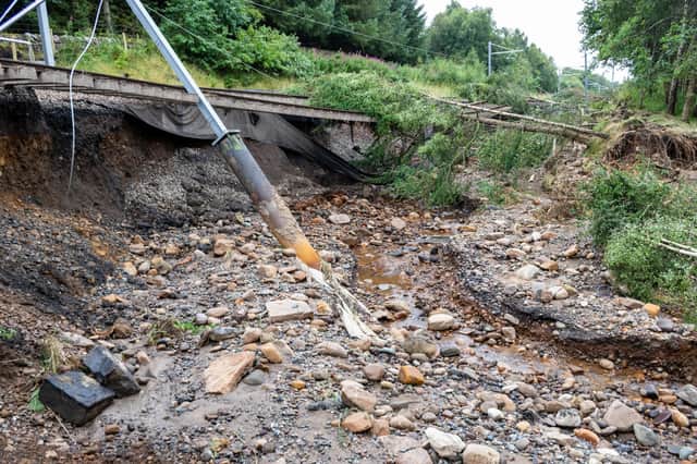 The force of the water washed away the embankment under the tracks and damaged the overhead power lines.  (Pics: Network Rail)