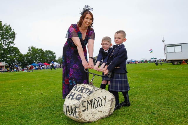 Chieftain Sharon Ritchie with her sons Jake (7) and Harris (5) attempts to lift the Smiddy Stane.
