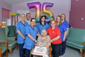 Annette Hall was born on the day NHS was founded on July 5, 1948 - pictured with staff and carers from Cunningham House in Grangemouth. Pic: Michael Gllen