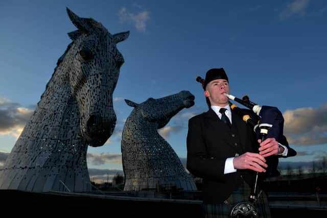 Robbie MacIsaac playing the bagpipes at The Kelpies