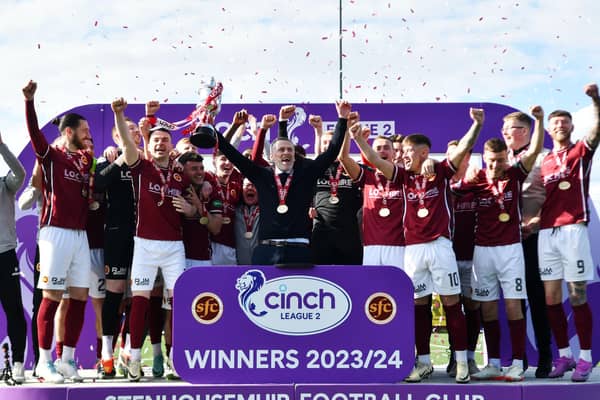 Manager Gary Naysmith lifts the League Two trophy aloft after Stenhousemuir's 1-1 draw with Bonnyrigg Rose at Ochilview (Photo: Michael Gillen)