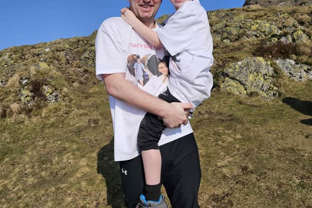 Finlay, pictured with his dad Steven, has raised over £1200 for the British Heart Foundation by climbing the hill - which he couldn't have done before his surgery.  (Pic: submitted)