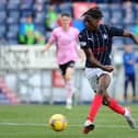 Samuel Ompreon goes for goal against Peterhead's Brett Long (Pictures by Michael Gillen)