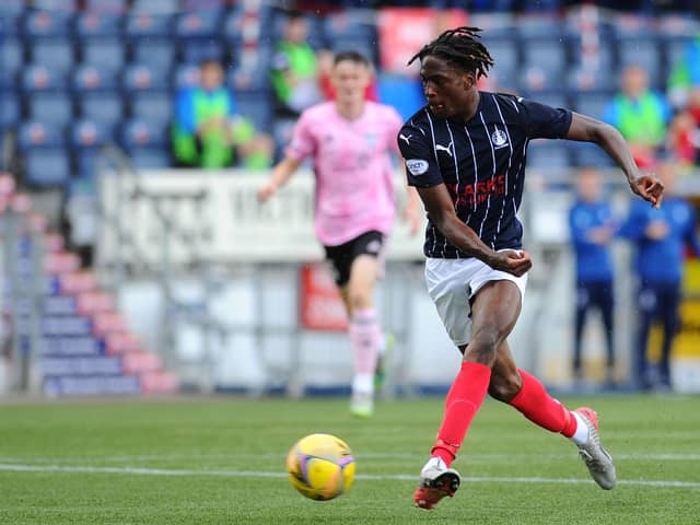 Samuel Ompreon goes for goal against Peterhead's Brett Long (Pictures by Michael Gillen)