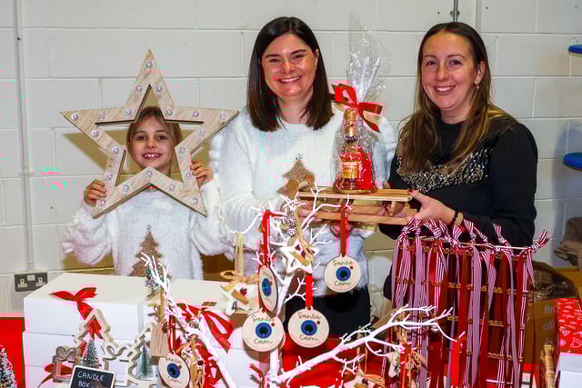 Jen and Kirsty with Jessica, eight, look after one of the many craft stalls.
