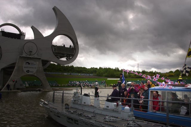 Crowds attend the official opening of the British Waterways Falkirk Wheel on the Union Canal by Queen Elizabeth II.