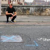 Daniel Campbell and fellow neighbours in Cow Wynd, Falkirk have complained about a noisy drain cover outside Comely Park Primary School that, they say, rattles every time a car passes over. Picture: Michael Gillen.