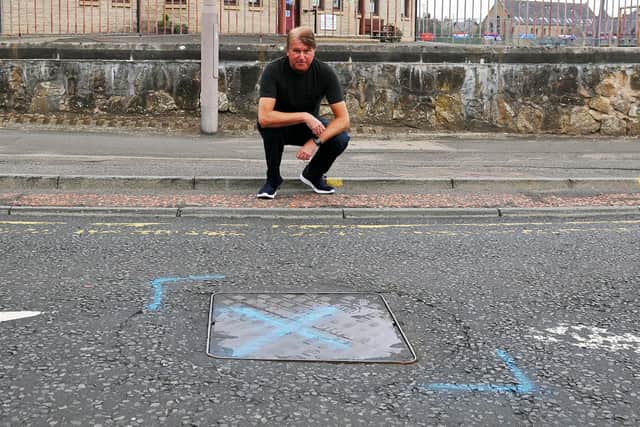 Daniel Campbell and fellow neighbours in Cow Wynd, Falkirk have complained about a noisy drain cover outside Comely Park Primary School that, they say, rattles every time a car passes over. Picture: Michael Gillen.