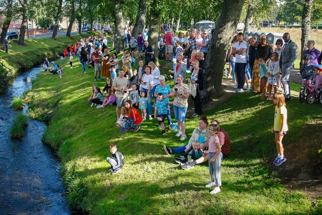 Crowds line the banks of the Grange Burn in Zetland Park awaiting the arrival of the ducks