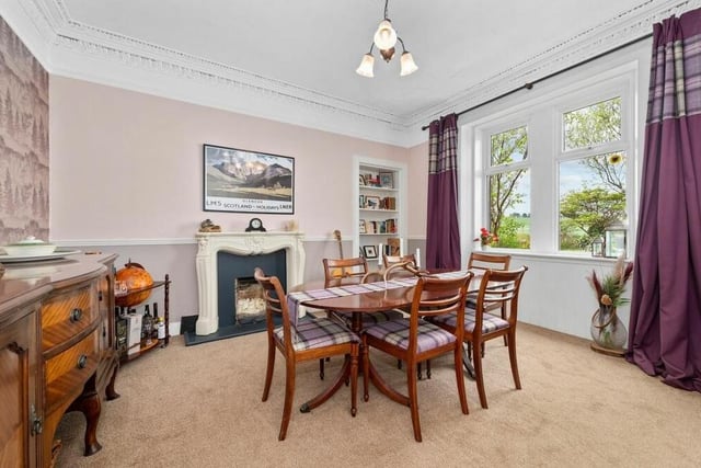 The cornicing, high ceilings and fireplace in the dining room show some of the period charms this cottage has to offer.