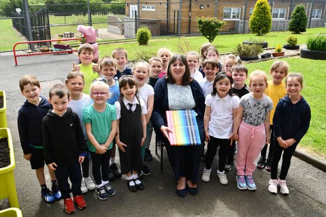 Rhona Gardner with some of her tiny charges as she takes early retirement after 37 years teaching at Shieldhill Primary