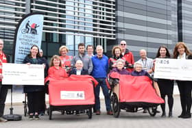Pictured are representatives from Petroineos and INEOS FPS with two trishaws, their pilots and passengers, who are residents of Cunningham House care home and enthusiastic users of Cycling Without Age Scotland’s services.