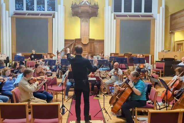 Michael Graham conducting members of Falkirk Tryst Orchestra in rehearsals.