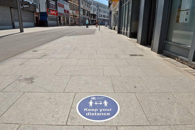 Doncaster town centre is being marked out with with social distancing signs, like these on the ground at Silver Street