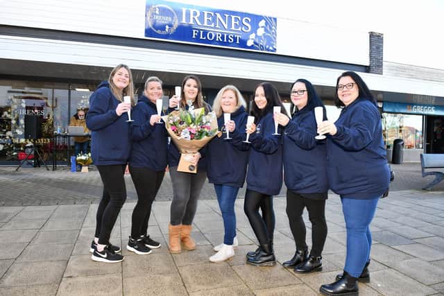 The team celebrate the opening of the big new shop