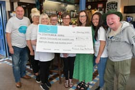 The fundraising efforts of staff and customers at the Railway Tavern raised over £7000 in memory of Richard 'Zoop' Borthwick.  Pictured from left: Tony Riddell, DJ; Kirsty Borthwick, Richard's daughter; Logan Steen, Richard's grandson; Jill Borthwick, Richard's wife; Linda Hardie, manager; Claire Kennedy, Strathcarron Hospice's corporate fundraiser; Natasha Hoehle, bar staff, and Matt Baxter, customer.  (Pic: Michael Gillen)