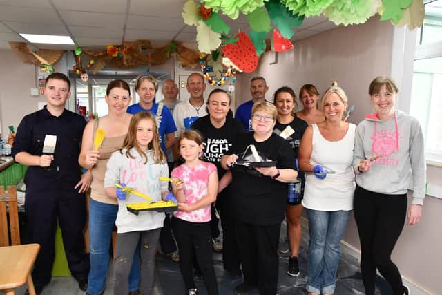 Polmont Playgroup committee and volunteers painting the inside of their building