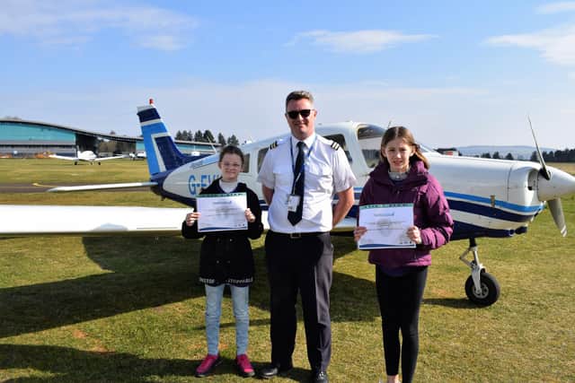 Brooke Lawless, pilot Andrew and Josie Anderson having completed their flight