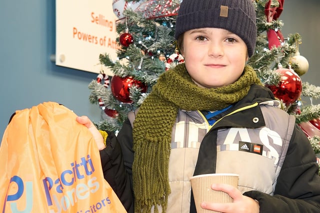 A young guest enjoys some refreshments and early Christmas treats in the Pacitti Jones grotto