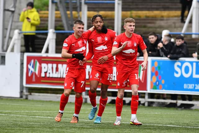 Rumarn Burrell is mobbed by team-mates Kai Kennedy and Finn Yeats after opening the scoring at Palmerston against QOS (Pics by Michael Gillen)