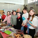 Lots of tasty treats on offer served up by some willing helpers.