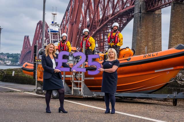 Taylor Wimpey East Scotland sales executives Jacqui Bryson Elder and Helen Allenby with members of the RNLI Queensferry crew. Photo - Chris Watt.