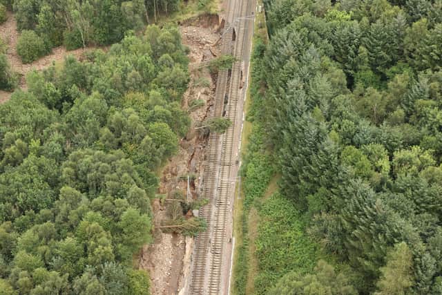 A 300 metre section of the main Edinburgh to Glasgow railway line has been damaged by the water from the breached Union Canal.