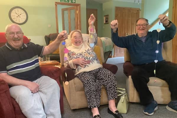 clients at the daycare with decorations they’ve made in the craft sessions