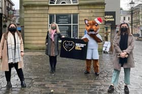 Falkirk Delivers team members hit the streets with Fergus the Fox, Falkirk Football Club's mascot, to hand out District Towns Gift Cards. Contributed.