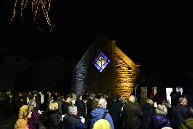 A stained glass window at Falkirk Trinity Church is lit in the colours of the Ukranian flag