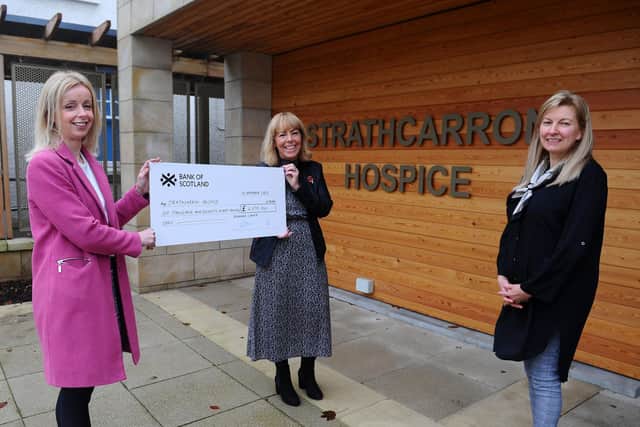 Drummond Laurie Chartered Accountants in Grangemouth hand over a cheque for £6078 after participating in Strathcarron's virtual 10k. Julie McVicar, associate director of Drummond Laurie, and Gillian Niven, its relationship manager, with Marion Blaney, Strathcarron Hospice community fundraiser. Picture: Michael Gillen.