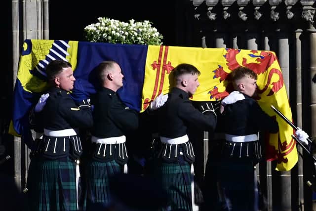 The coffin of Queen Elizabeth II leaves St Giles Cathedral carried by soldiers from 5 Scots. Pic: John Devlin