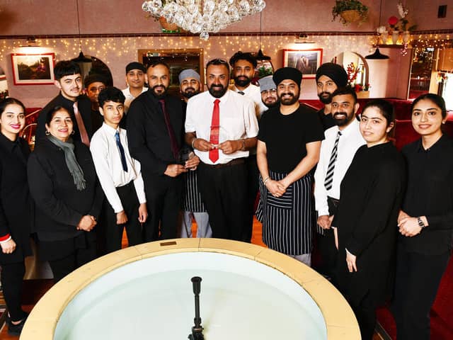 Boota Singh, owner of Gulnar Tandoori, with sons Jaskaran and Navjot, and the rest of the family and staff after the restaurant was named Outstanding Indian Restaurant of the Year at the Scottish Curry Awards.  (Pic: Michael Gillen)