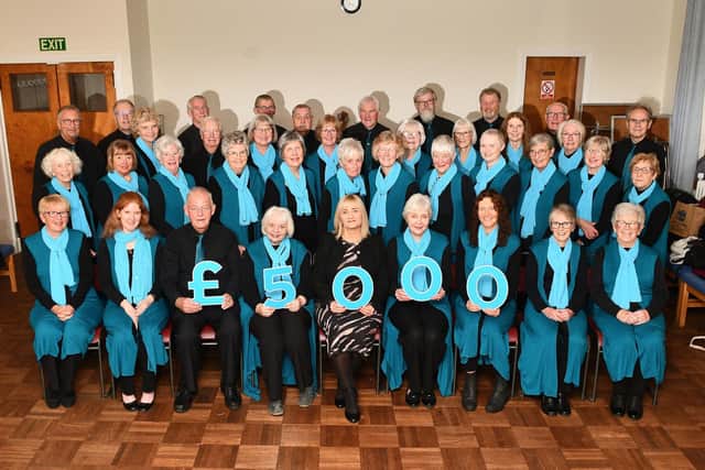 Strathcarron Singers present to hospice CEO Mags McCarthy, centre. Pic: Michael Gillen