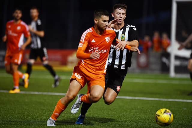 Captain Jason Walton shields the ball from his midfielder counterpart