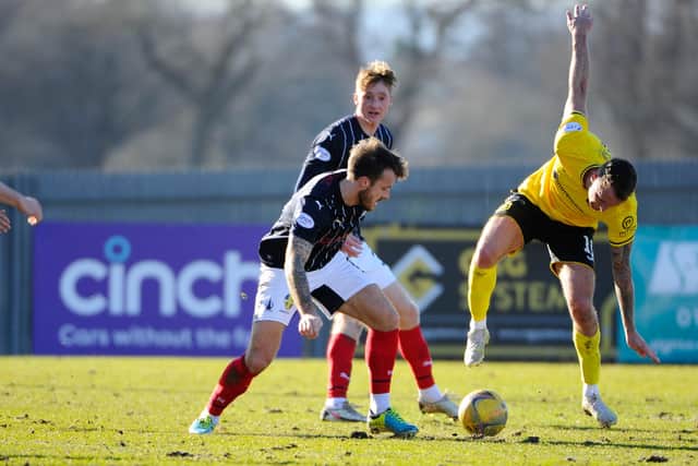 Steven Hetherington looks to win the ball