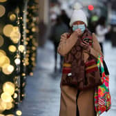 A member of the public wearing a face covering shopping on Buchanan Street in Glasgow, Scotland where severe lockdown restrictions have been announced for December and January with most of the country moving into the highest level of lockdown from Boxing Day.