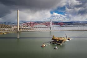 Aerial image of the Iron Lady barge with its cargo of a topside drilling platform for decommissioning being towed by Forth Ports tugs at the Forth Bridges into The Port of Rosyth on Sunday , April 11. Credit: Airbourne Lens