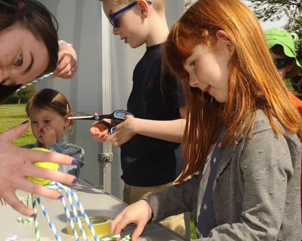 Emma Dillon (5) making a structure to hold a tennis ball out of straws at last year's Innovate event in Zetland Park, Grangemouth.  (Pic: Alan Murray)