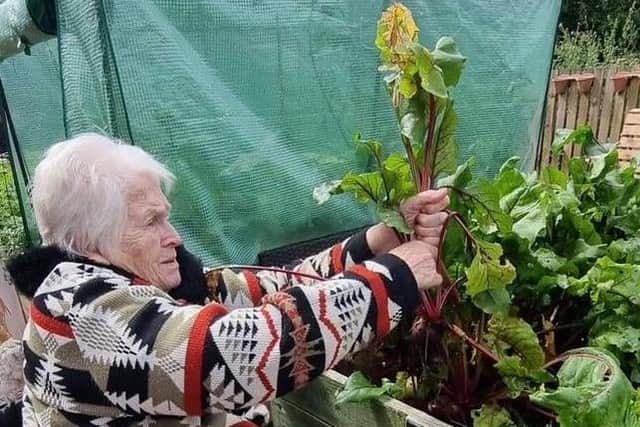 Susan Elliot, 89, tends to the garden at Newcarron Court Care Home