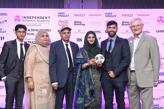 Asiyah and Jawed Javed with their family as they pick up their award.  (Pic: Submitted)
