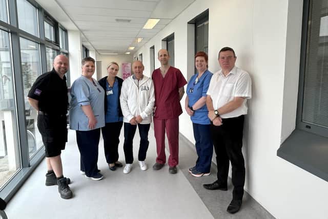 Father and son John, middle, and Barry Main, far left, join surgeon Alistair Geraghty, stoma care nurse Jennifer Thomson, staff from our oncology support team and representatives of the Jolly Beggars Burns Club (Picture: Submitted)
