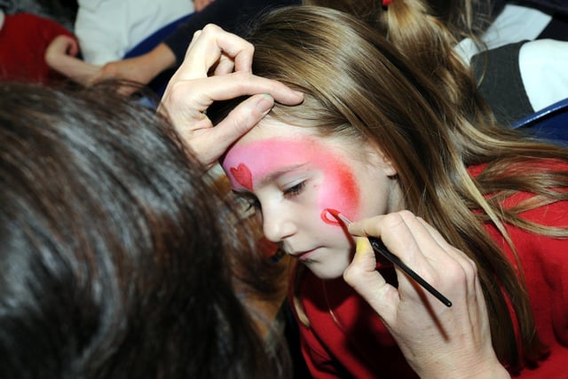 Face painting love hearts.