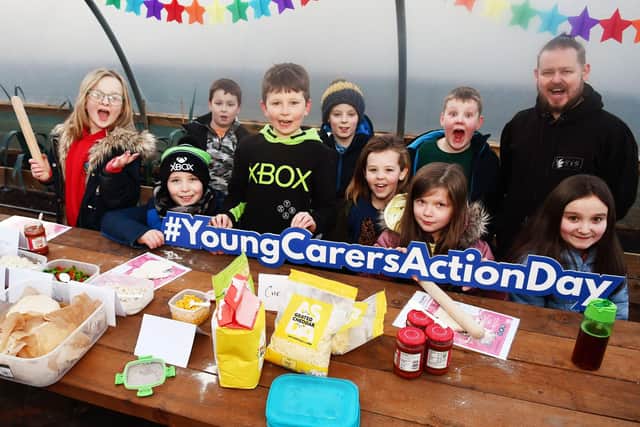 Ahead of Young Carers Action Day, youngsters enjoyed a pizza party hosted by Sustainable Thinking Scotland. Picture,  Sean Kerr director, Sustainable Thinking Scotland, with the children.