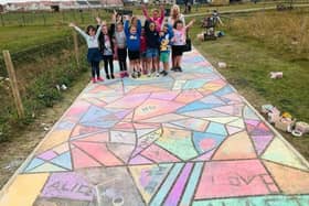 Local school pupils were delighted to be able to make their mark on the local park, pictured here having chalked the pavement.